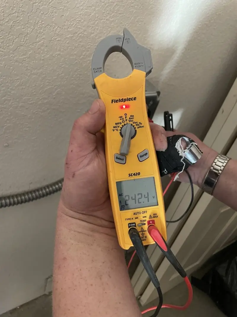 Voltage testing with clamp meter during Outlet Installation in Hebbronville